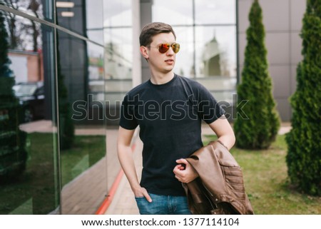 A stylish man in a black T-shirt. Street photo