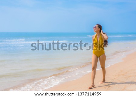 Portrait beautiful young asian woman smile happy and leisure on the beach and sea for vacation travel concept
