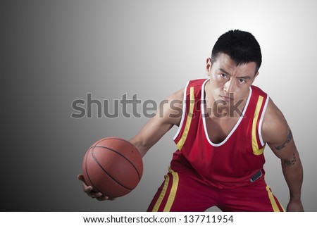 Portrait of young man holding a basketball