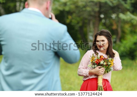 Young man photographing a girl