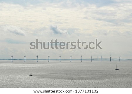 Ocean wind turbines near the port of Copenhagen, Denmark. Renewable energy concept image. 
