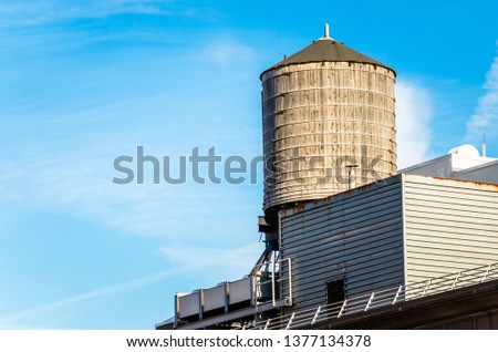 Traidtional Wooden Rooftop Water Tank in New York on a Sunny Winter Morning