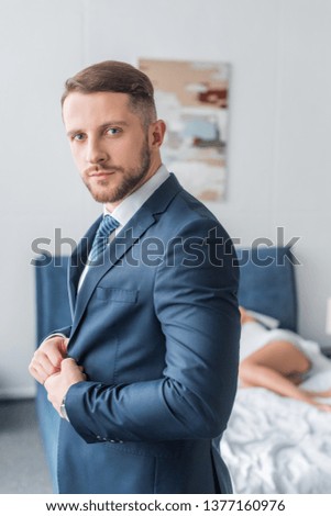handsome bearded man touching formal wear near sleeping woman 