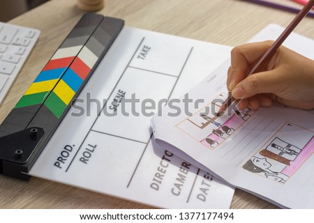 Storyboard drawing with pencil creative sketch cartoon. Storyboarding is process image displayed in sequence for purpose of pre-visualizing motion picture, interactive media. Concept sketching ideas. Royalty-Free Stock Photo #1377177494