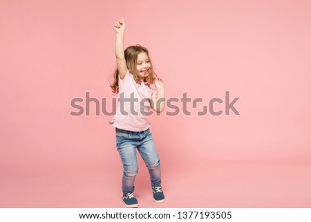 Little cute child kid baby girl 3-4 years old wearing light clothes dancing isolated on pastel pink wall background, children studio portrait. Mother's Day, love family, parenthood childhood concept Royalty-Free Stock Photo #1377193505