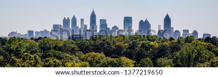 Downtown Atlanta Skyline showing several prominent buildings and hotels under a blue sky as seen from Buckhead in North Atlanta Royalty-Free Stock Photo #1377219650