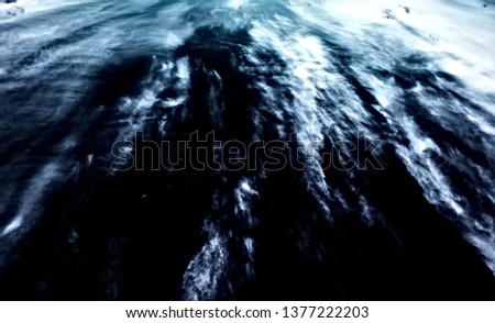 Bright white cirrus clouds pictured through a polarized filter. Strongly graphical, abstract, polarized digital image.