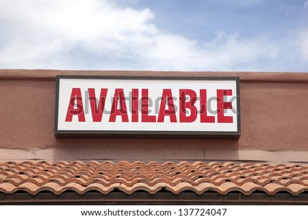 Available sign on stucco building with red tile roof
