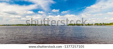 Summer landscape: River, sky, clouds, Church bell tower on the water