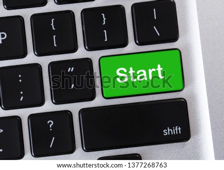 New beginning concept. Green Start button on computer keypad, closeup