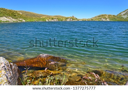 Clear summer lake in rocky mountains, landscape in Fagaras mountains.