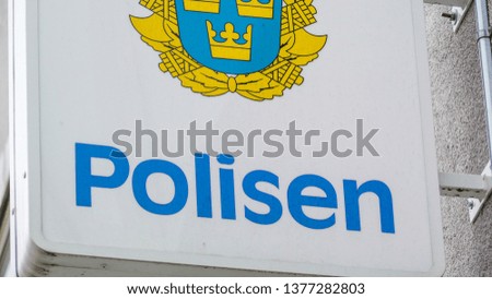 The police station signage outside the building with the logo of the station on it
