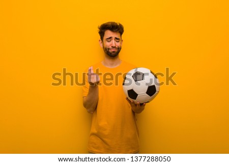 Young soccer player man doing a gesture of need