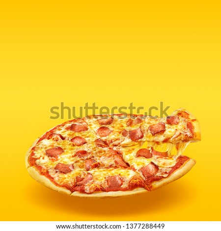 Creative layout of hot delicious pizza in flying on summer orange background. Pizza pepperoni design mockup flyer or poster for promotions and discounts with copy space. Fast Food concept.
