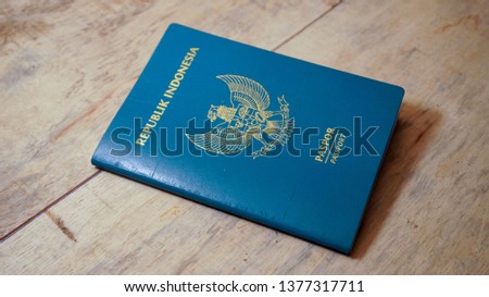 Top view of indonesian passport on wooden desktop - Image Royalty-Free Stock Photo #1377317711