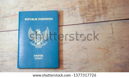 Top view of indonesian passport on wooden desktop - Image Royalty-Free Stock Photo #1377317726