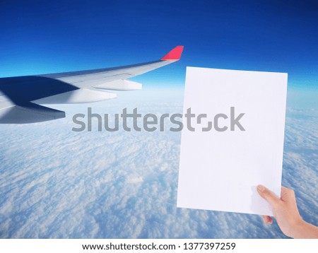white paper in woman hand on blue sky 