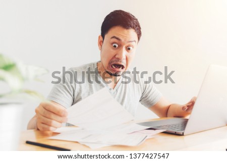 Shocked and Surprised Asian man has the problems with billing and debts.
