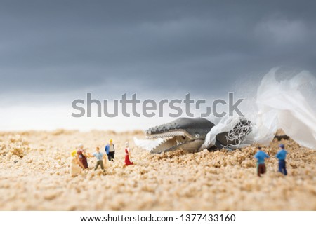 Dead whale on beach. Environmentalism and plastic awareness concept background. 