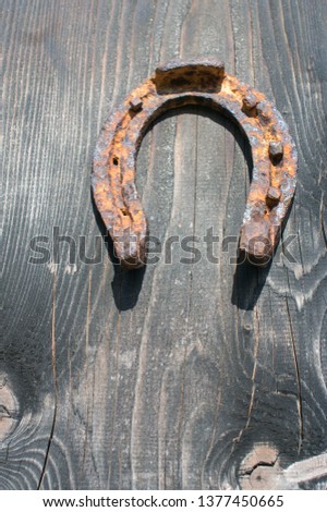 horseshoe displayed on barn wall