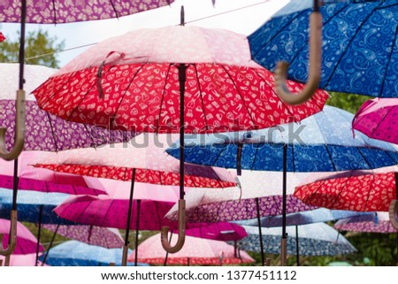 Colorful umbrellas, urban street decoration. Summer umbrella festival. Umbrellas hanging from the sky. Beautiful background image. Umbrella Sky Project. São Roque, São Paulo, Brazil