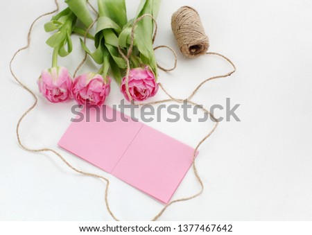 tulip bouquet and blank card on a white background