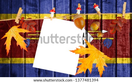 Swaziland flag on autumn wooden background with leaves and good place for your text.