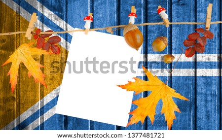 Tuva flag on autumn wooden background with leaves and good place for your text.