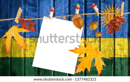 Rwanda flag on autumn wooden background with leaves and good place for your text.