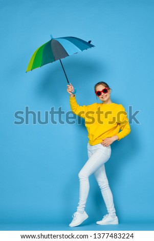  woman with an umbrella colored on a blue background                             