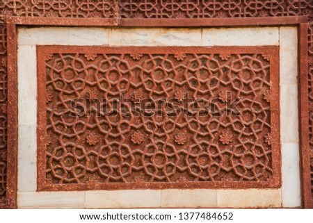 Geometrical pattern and decorative detail of sandstone carving in Red Fort. Agra, UNESCO World heritage site.