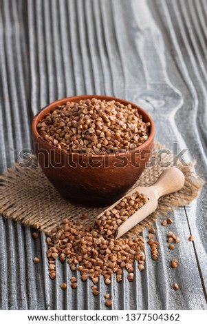 Grain buckwheat on a gray wooden background