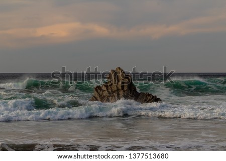 rock in the sea, which is hit by the waves. On the beach of Atxabiribil in Sopelana
