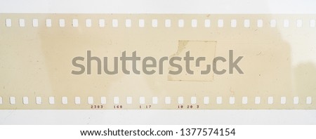 blank and empty 35mm film strip on white background, real 135 movie material