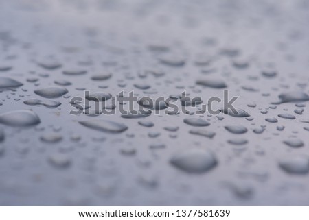 rain drops on a gray metal surface 