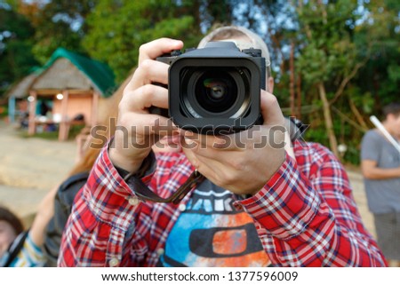 A young man takes pictures while traveling.