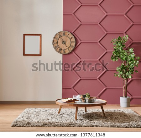 Modern claret red wall detail with white background, grey sofa and pillow, white bookshelf middle table and orange lamp style, frame and chair decor. Royalty-Free Stock Photo #1377611348