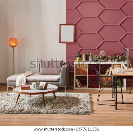 Modern claret red wall detail with white background, grey sofa and pillow, white bookshelf middle table and orange lamp style, frame and chair decor. Royalty-Free Stock Photo #1377611351