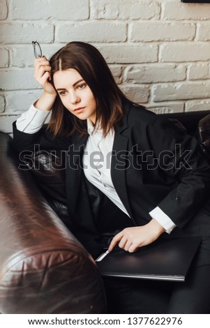 Young attractive woman student after exams siting at cafe and relaxing