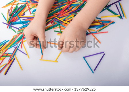 Kid making rectangular  and triangle shape as creative concept