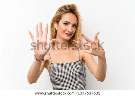 Young blonde woman over isolated white counting eight with fingers