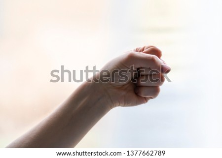 Hand of woman in gesture isolated on blurred background