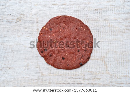 Red velvet cookies, butter cookies on white wooden background, close up, top view
