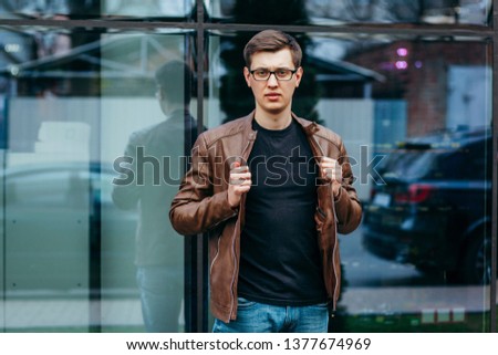 A stylish man in a black T-shirt. Street photo
