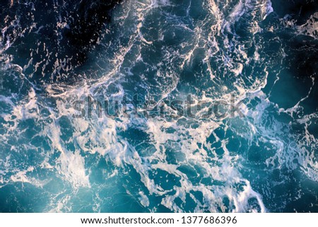 AERIAL VIEW OF THE SEA WITH WHITE WAVES Royalty-Free Stock Photo #1377686396