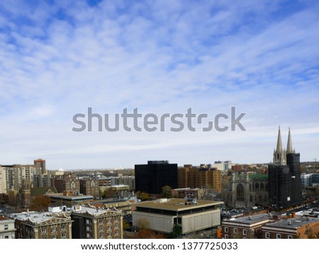 City view of Denver, Colorado with a bright blue sky and cirrocumulus clouds
