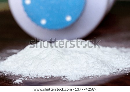 close up picture of baby powder on wooden background, dangerous for health
