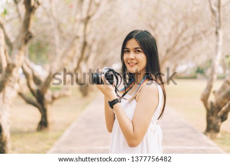 person looking and take photo over a landscape, female traveler photograph at  hight forest mountain Asia at sunrise,Hiker look to sunlight in trip in Thailand country,cheerful emotions great