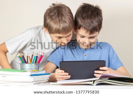Kids using together tablet computer at home