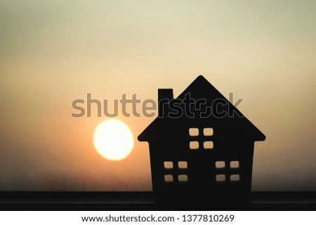 Silhouette hard paper house on floor , a symbol for construction , ecology, loan, mortgage, property or home.
